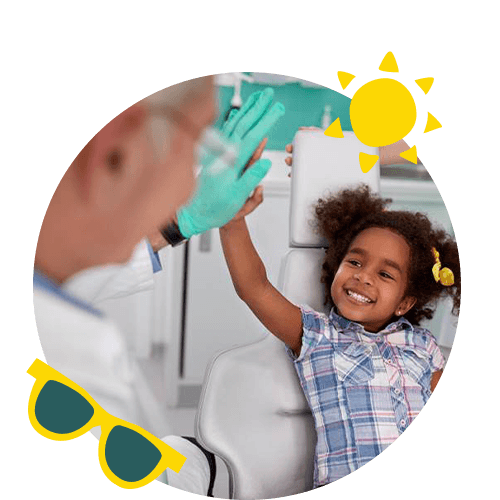 young girl smiling and high fiving dentist in Scottsdale