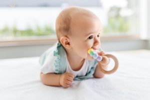Child chewing on a teething ring