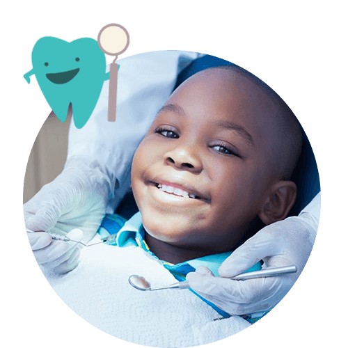 young boy smiling while sitting in dental chair
