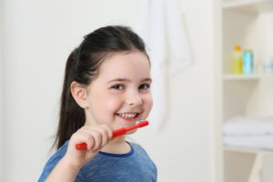 little girl brushing teeth