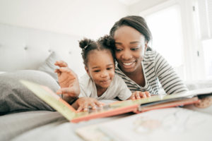 parent and child reading book together