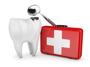 Model tooth next to red emergency kit